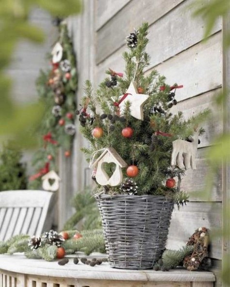 Christmas tree in a basket, tiny pinecones and clay ornaments