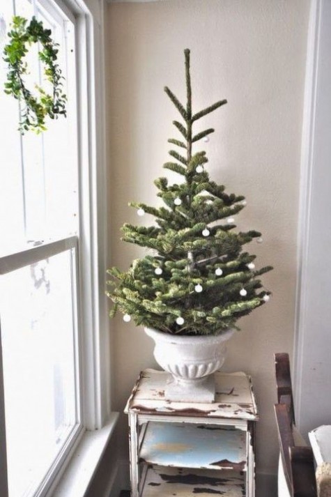 a white urn echoes with tiny white ornaments