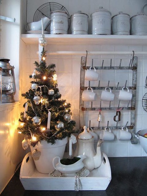potted tree with silver ornaments and lights