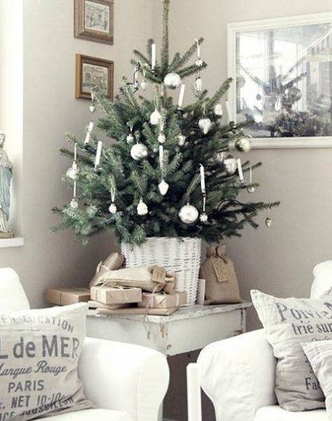 tabletop tree with white and silver ornaments and a white basket