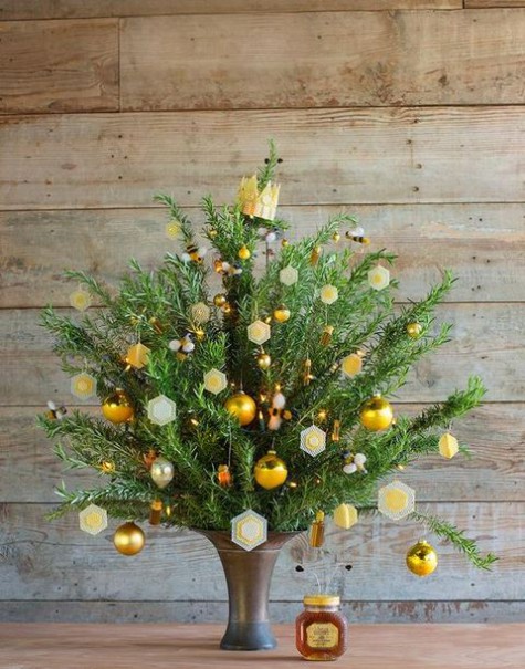 tree in a vase with sparkly gold decor