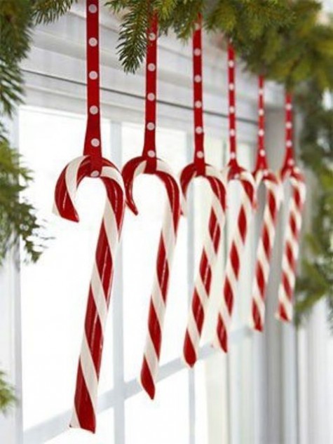 candy canes hanging on a fir garland