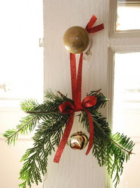 evergreen sprigs with a gold jingle bell and a red bow