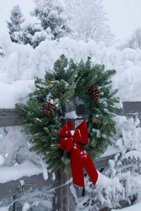evergreen wreath with pinecones and a red bow
