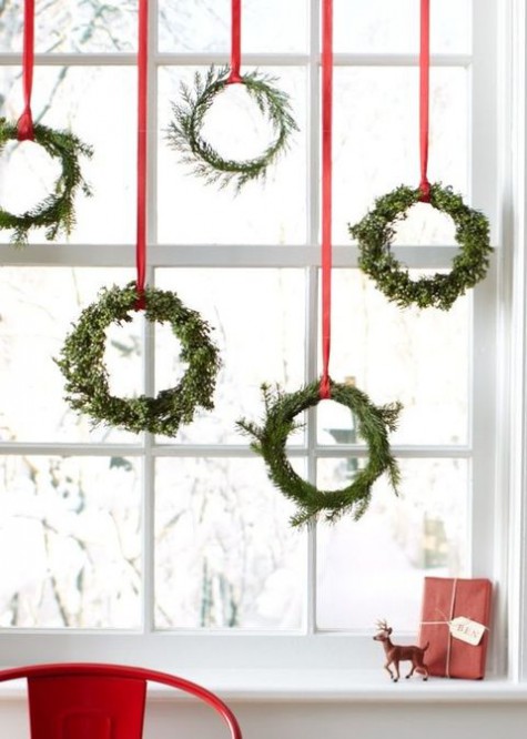mini wraths with red ribbon hung on the window