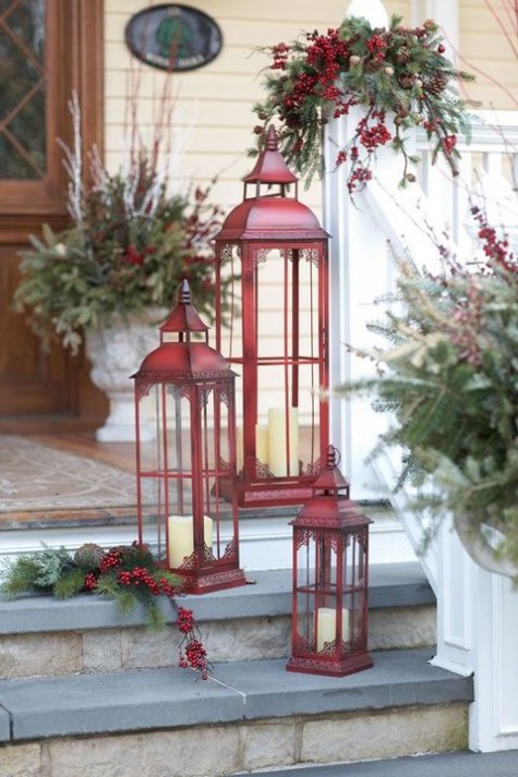red candle lanterns and evergreens