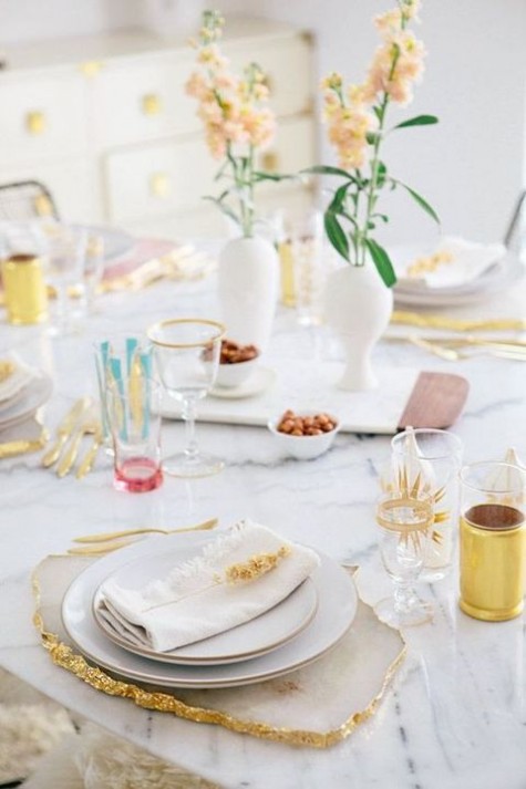 a table setting with a rough gilded charger and colorful touches