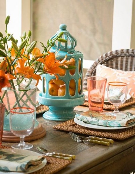 oranges in a vase, orange lilies for a centerpiece and wicker chargers