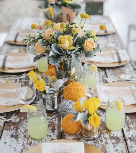shabby wooden table, yellow and grey yarn balls, yellow roses and billy balls, gilded chargers