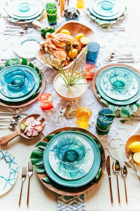 turquoise chargers, palm leaves, colorful glasses and glass bowls