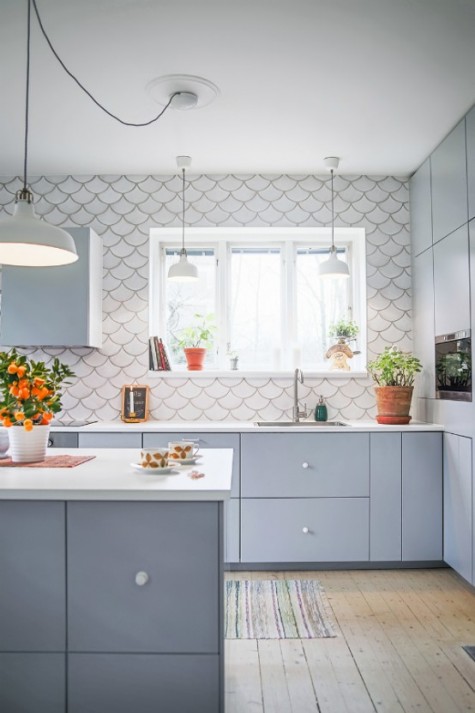 a matter grey kitchen with a white fishscale tile backsplash