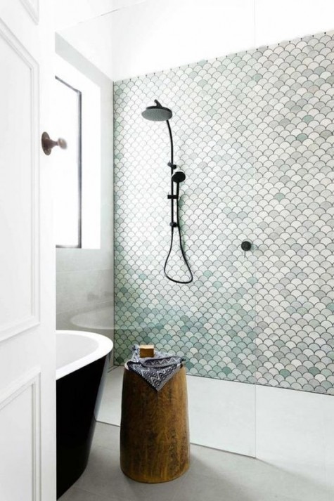 a simple shower is made cooler with aqua-colored, white and blush fishscale tiles