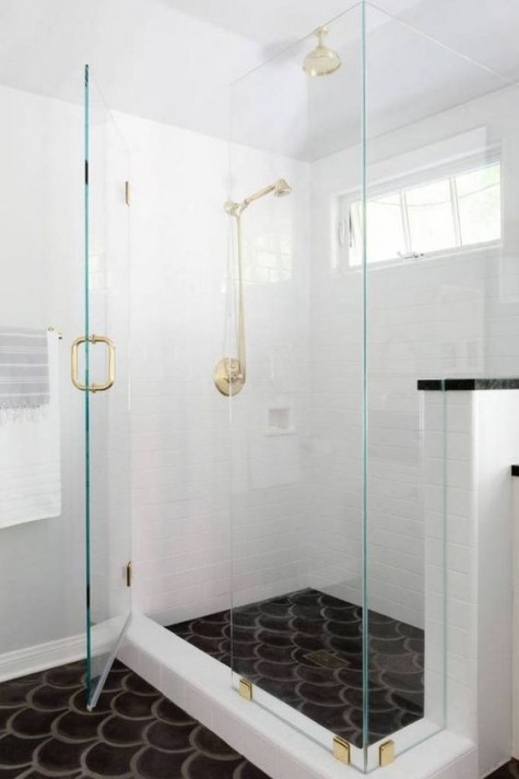 a white bathroom and a black fishscale tile floor for a creative look