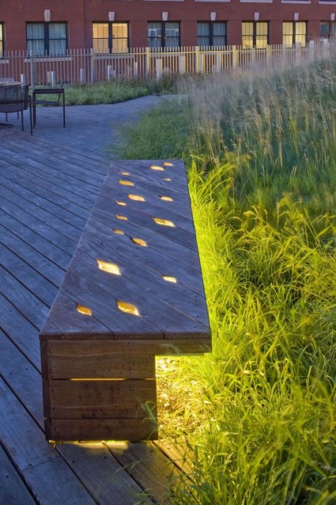 a wooden bench with cutouts and lights inside