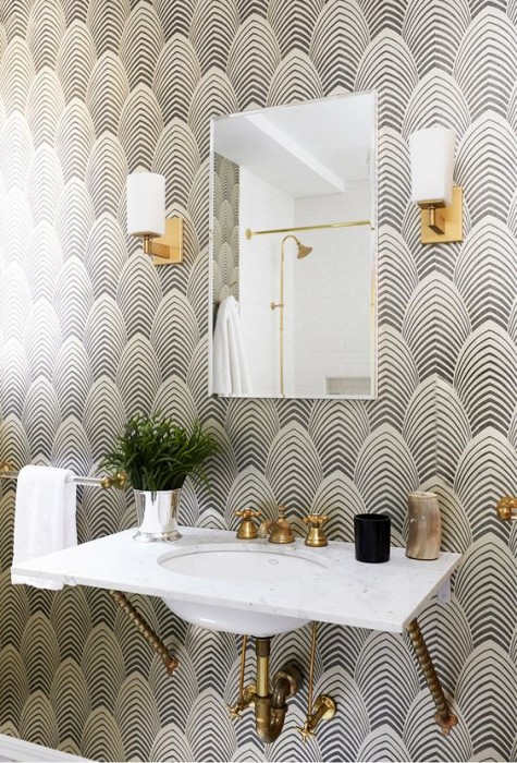an art deco bathroom complemented with a black and white wallpaper wall
