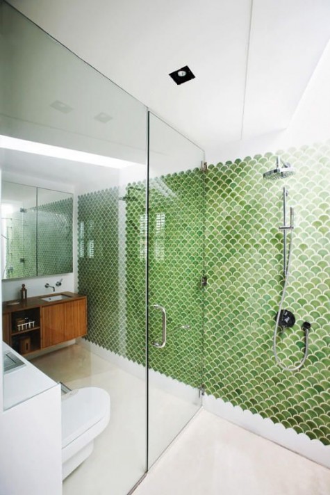 green fishscale tiles define a bathroom wall