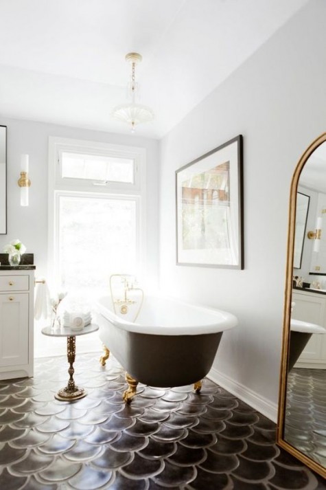 large black fishscale tiles that cover the bathroom floor make the space amazing