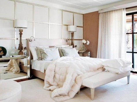 mirror nightstands, a faux fur bedspread and a metallic square statament wall give a glam feel