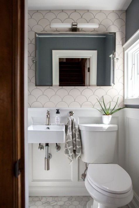 oversized fishscale tiles make this tiny powder room more eye-catching