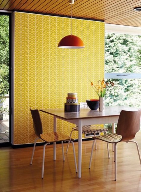yellow retro print wallpaper makes the dining space sunnier