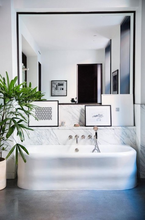 a chic modern mirror covers one of the walls and doubles the space