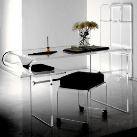 a desk with rounded ends and a stool with acrylic legs on casters