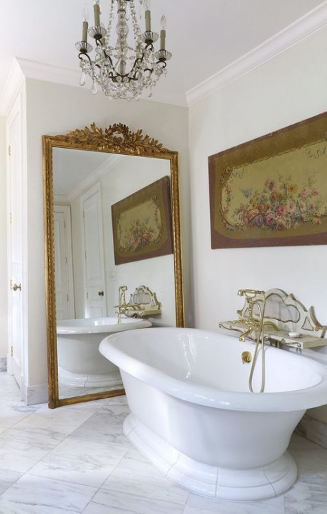 a large mirror in a vintage frame makes the bathroom refined and chic