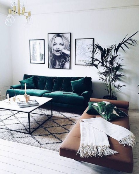 a modern emerald green sofa looks amazing with a brown leather couch