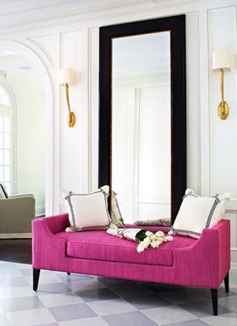 a modern mirror in a black frame makes the entryway glam and chic