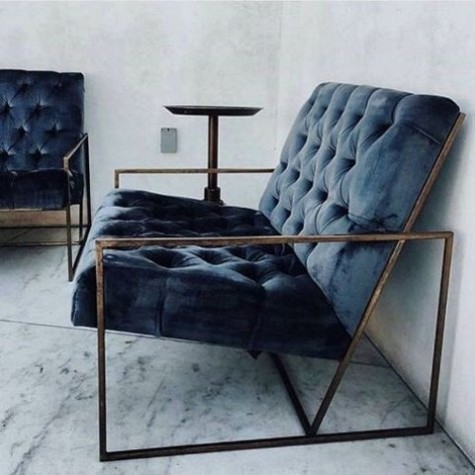 a modern navy diamond upholstery loveseat with an industrial feel