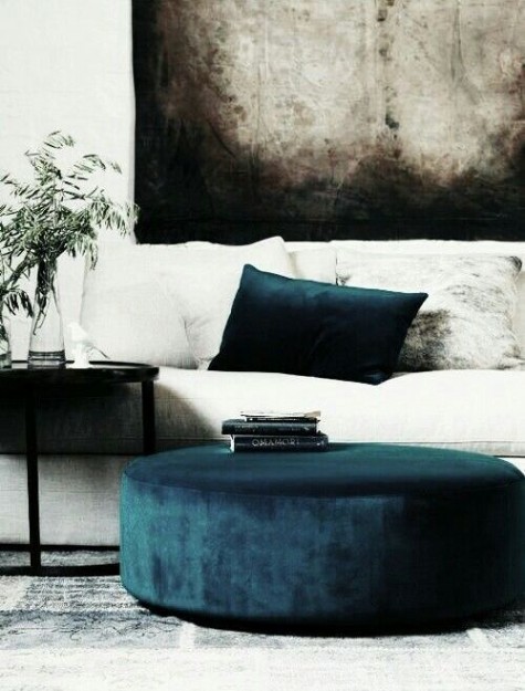 a navy velvet ottoman and pillow for a chic and cozy look