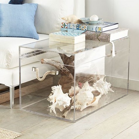 an acrylic chest doubles as a side table and a storage piece