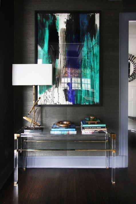 an acrylic table with brass touches looks very elegant