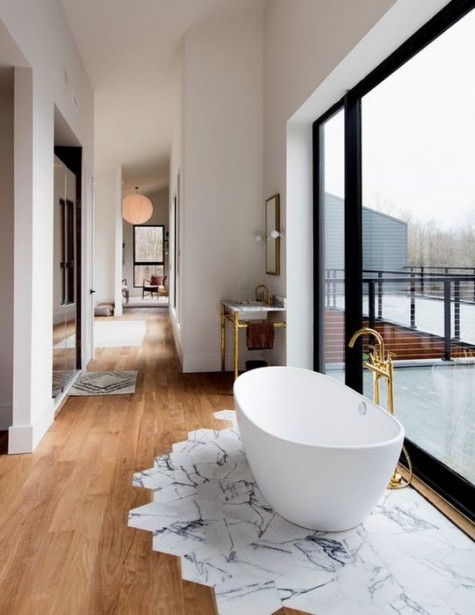 highlight the bathtub zone with hexagon marble tiles around to save the wooden floors around