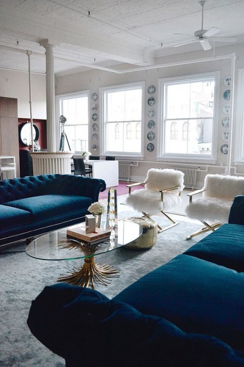 two navy velvet sofas placed opposite each other