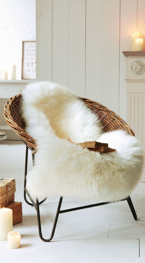 a round wicker chair covered with faux fur looks winter-ready