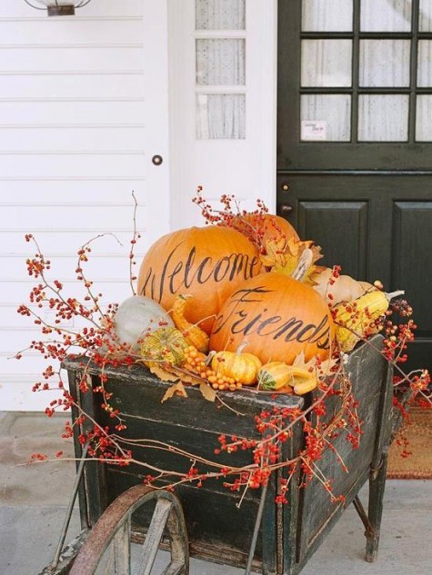 a barrow with oversized pumpkins_ berries_ faux gourds