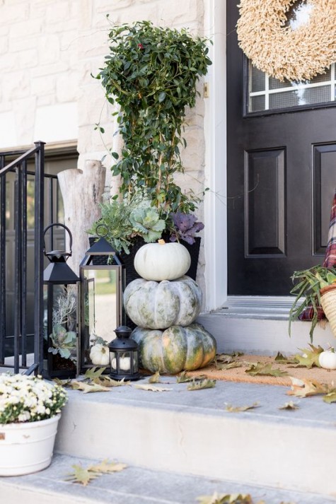 a neutral porch with modern lanterns_ succulents_ driftwood_ greenery and leaves