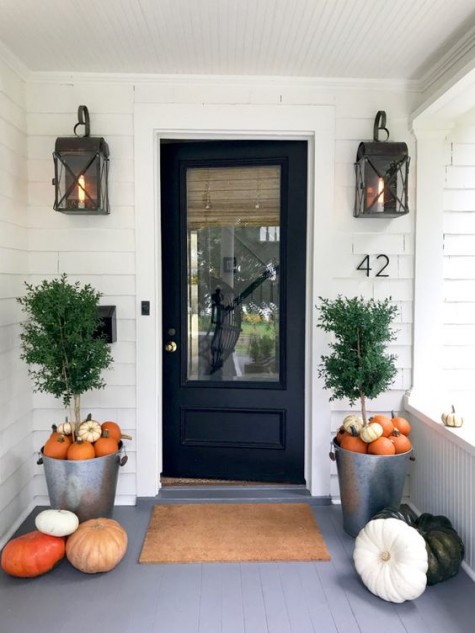 galvanized buckets with pumpkins and large ones placed right on the porch