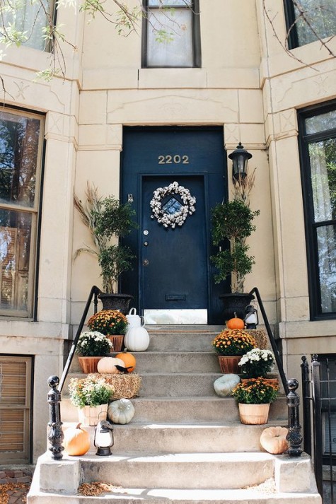 hay_ pumpkins_ potted flowers_ a cotton wreath and lanterns