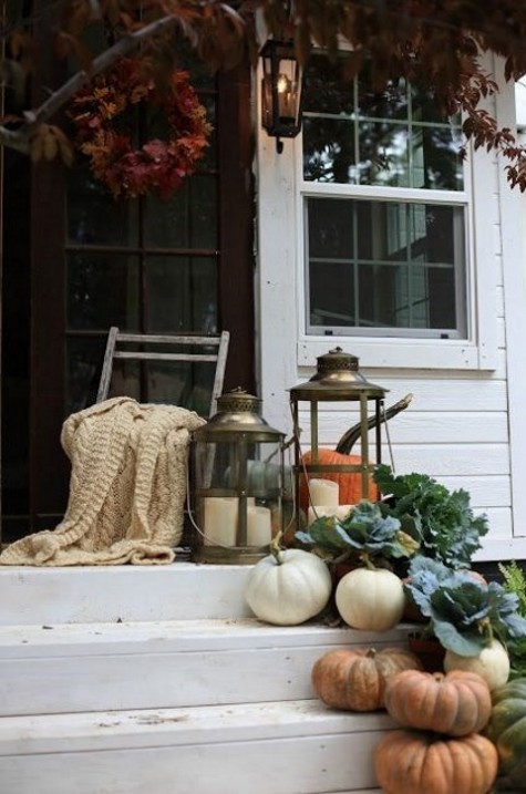 steps with real pumpkins_ veggies_ large lanterns_ a blanket on the chair and fall leaves
