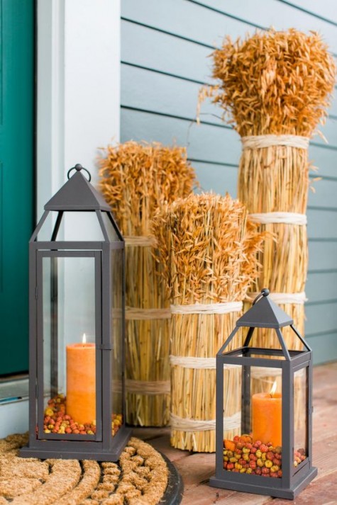 wheat and lanterns with orange candles for a fall porch
