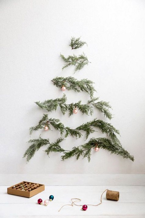 Christmas tree branches on the wall with pearly ornaments