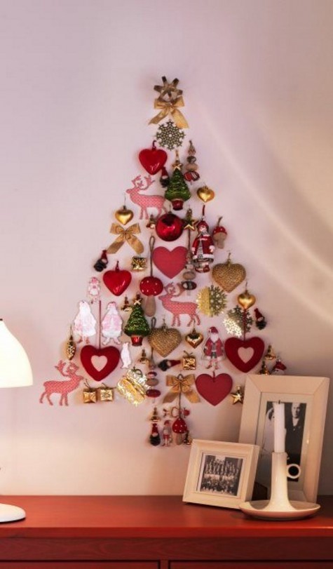 a Christmas tree shaped of christmas ornaments right on the wall