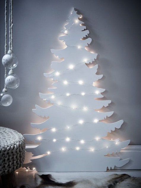 a Christmas tree silhouette wall art with lights