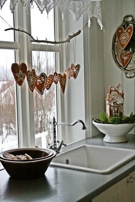 a branch with glazed gingerbread cookies hanging on it
