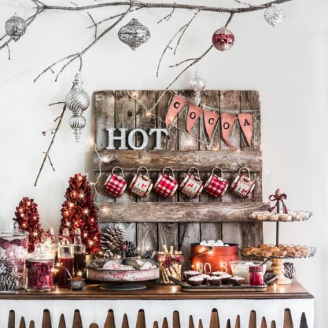 a gorgeous hot chocolate bar with ornaments_ pinecones and lots of lights