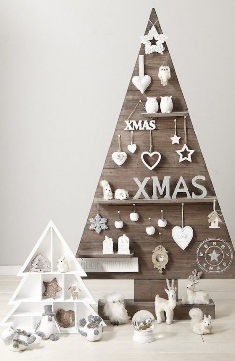 a plywood Christmas tree with shelves with figurines and ornaments