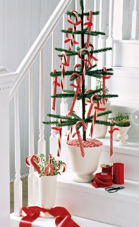 a potted faux tree with candy canes for decor