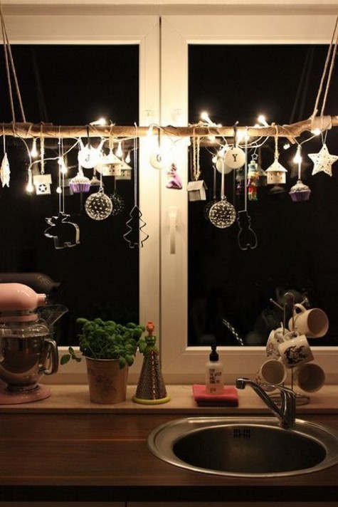 a pretty garland with lights_ tiny cupcakes_ stars and houses